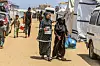 Palestinian women received a share of food from a distribution site operated by a charity providing hot meals to Palestinians in the Al-Mawasi area of Khan Yunis, Gaza, on May 12. [UPI/YONHAP]