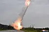 North Korean leader Kim Jong-un inspects a test-firing of a new 600-millimenter multiple rocket launcher, in a photo provided by the North's official Korean Central News Agency on Friday. [YONHAP]
