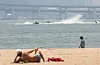 A lays by the Gwangalli Beach in Busan on June 27. [YONHAP]