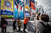 People take photographs in front of the Dotonbori Glico Sign in Osaka on Dec. 1, 2022. [AFP/YONHAP]