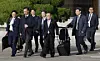 National Security Adviser Wi Sung-lac, center, and other presidential aides walk toward Air Force One at Seoul Air Base in Seongnam, Gyeonggi, on Nov. 17. They are accompanying President Lee Jae Myung on his trip to the Group of 20 summit in South Africa. [JUN MIN-KYU]