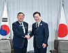 President Lee Jae Myung and Japanese Prime Minister Shigeru Ishiba shake hands during a Korea-Japan summit on June 17 on the sidelines of the Group of 7 (G7) summit in Kananaskis, Alberta, Canada. [JOINT PRESS CORPS]