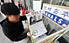 A student places a special edition of the Yonsei Chunchu, celebrating author Han Kang for winning the Nobel Prize in Literature, on a newspaper stand on Friday. [NEWS1]