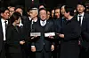 Democratic Party leader Lee Jae-myung, center, speaks to reporters at the Seoul High Court in Seocho District, southern Seoul, on March 26, after the court acquitted him on all counts of lying during his last presidential campaign. [YONHAP]