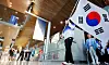 Fencer Gu Bon-gil, center, an Olympic gold medalist, carries the national flag, Taegeukgi, as the South Korean main delegation for the Paris Olympics arrives at Paris Charles de Gaulle Airport in France on Saturday, ahead of the Summer Games. [YONHAP]