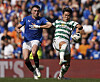 Rangers' John Souttar, left, and Celtic's Oh Hyeon-gyu battle for the ball during a Scottish Premiership match at the Ibrox Stadium in Glasgow on Sunday.  [AP/YONHAP]