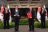 Korean President Yoon Suk Yeol, left, and Singaporean Prime Minister Lawrence Wong, right, watch Finance Minister Choi Sang-mok, center left, and his Singaporean counterpart, Gan Kim Yong, center right, sign a memorandum of understanding on liquefied natural gas cooperation at the Parliament House in Singapore on Wednesday. [JOINT PRESS CORPS]