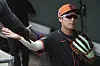 The San Francisco Giants' Lee Jung-hoo slaps hands as he walks through the Giants' dugout prior to a spring training baseball game against the Texas Rangers on March 13. [AP/YONHAP]