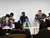 Photo journalists take close-up photos of ADOR CEO Min Hee-jin as she sits down for her press conference Thursday in southern Seoul. [CHO YONG-JUN]
