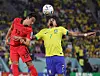 Korea's Son Jun-ho, left, vies for the ball with Brazil's Lucas Paqueta during a 2022 World Cup round of 16 match at Stadium 974 in Doha, Qatar on Dec. 6, 2022. [YONHAP]