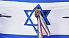 An Iranian man punches through a representation of the Israeli flag with the Iranian flag ribbon tied to his wrist in an anti-U.S. and anti-Israeli rally at Enqelab-e-Eslami (Islamic Revolution) square in downtown Tehran, Iran, Tuesday, June 24, 2025. [AP/YONHAP]