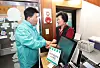 Hana Financial Group Chairman and CEO Ham Young-joo, left, greets a small business owner on March 26. The executive visited mom-and-pop stores affected by fires last year as part of his first public appearance since was elected to a second term. [HANA FINANCIAL GROUP]