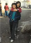 President Lee Jae-myung, right, and his childhood friend Shim Jeong-woon pose in an alleyway in Seongnam, Gyeonggi, in 1980. [SHIM JEONG-WOON]