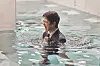 A scene from the Netflix original series ″Daily Dose of Sunshine,″ where a character's anxiety attack is expressed through water filling up the space and submerging the character [NETFLIX]