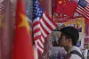 A man walks into a merchandise store displaying Chinese and United States' national flags in Beijing on April 3. [AP/YONHAP]