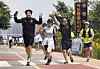 Runners who participated in Seoul city's triathlon event wave their hands as they cross the finish line in Ttukseom Hangang Park in eastern Seoul on May 30. [PARK SANG-MOON]