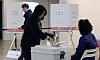 A voter casts her ballot at a polling station in Guro District, southwestern Seoul, during the by-elections on April 2 to elect a new district chief. [NEWS1]