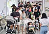 Parents and their children in their strollers crowd a festival for families with young kids in Incheon in August last year. [NEWS1]