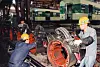 A worker dismantles and repairs a subway train at a maintenance depot. [JOONGANG ILBO]