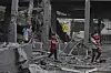 Palestinians inspect the damage at a U.N. school used as a shelter by displaced residents that was hit by Israeli military strikes, killing more than 15 people, in Jabaliya, northern Gaza Strip, on May 12, 2025. [AP/YONHAP]