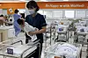 A nurse holds up a baby in a neonatal room at a hospital in Gangseo District, western Seoul, on Feb. 26, when the government announced that the total fertility rate rebounded for the first time in 9 years through the 2024 population trend data. [JUN MIN-KYU]