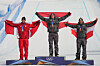Silver medalist Canada's Eliot Grondin, left, gold medalist Austria's Alessandro Haemmerle, center, and bronze medalist Austria's Jakob Dusek celebrate with flags during the men's snowboard cross finals at the 2026 Winter Olympics, in Livigno, Italy, on Feb. 12.  [AP/YONHAP]