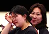 Oh Ye-jin, left, wipes away tears after winning the women's 10-meter air pistol contest at the Chateauroux Shooting Centre in Paris on Sunday. [EPA/YONHAP]