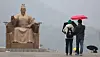 People walk with umbrellas at Gwanghwamun Square in Jongno District, central Seoul, on March. 2. [NEWS1]