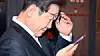 Former Democratic Party leader Lee Jae-myung looks at his phone after meeting with workers in Jongno District, central Seoul, on May 1. [JOONGANG ILBO]