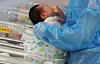 A baby is tended to by a nurse at a hospital in Goyang, Gyeonggi, on Nov. 26, 2025. [YONHAP]