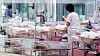 A staff member cares for newborns in a nursery at a postpartum care center in Seoul on Feb. 28, 2024. [YONHAP]