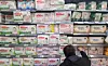 A consumer looks through diaper products at a supermarket in Seoul on Oct. 27, 2021. [YONHAP]