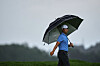 Tom Kim uses an umbrella as he walks down the 18th fairway during the third round of the U.S. Open golf tournament at Oakmont Country Club in Oakmont, Pennsylvania, on June 14. [AP/YONHAP]