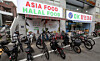 Foreign workers at Samsung Heavy Industries stop by an Asian market to buy food after finishing their work in Geoje, South Gyeongsang on June 5. [SONG BONG-GEUN]