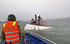 This image from a video provided by QDND shows people on a capsized tourist boat being rescued in Ha Long Bay, Vietnam on July 19. [AP/YONHAP]