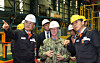 Hanwha Ocean CEO Kim Hee-cheol, left, briefs U.S. Chief of Naval Operations Adm. Daryl Caudle, center, on the company's shipbuilding capabilities at a naval ship construction site in Geoje. [YONHAP]