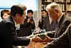 Lee Jae-myung, leader of the liberal Democratic Party, left, presents a gift to former President Moon Jae-in in Moon's residence in South Gyeongsang, on Jan. 30. [DEMOCRATIC PARTY]