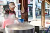 A restaurant staff member boils someori gukbap, or cow head soup, in a large pot. [JANGHEUNG COUNTY OFFICE]