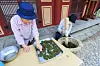 Temple workers grind and dry steamed tea leaves. [JANGHEUNG COUNTY OFFICE]