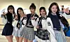 Girl group IVE members pose for a photo wearing Yonsei gwajam. [IVE'S OFFICIAL FACEBOOK ACCOUNT]