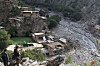 People stay outside damaged houses after a mudslide hit the area during heavy flooding in Nuristan province, east of Kabul, Afghanistan, on July 31, 2021, in this file photo. [AP/YONHAP]