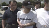 Lee Eun-seok, who murdered his parents, is escorted by police in this undated screen capture. [SCREEN CAPTURE]