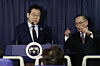President Lee Jae Myung, left, and National Security Advisor Wi Sung-lac speak during a press conference with reporters aboard the Korean Air Force One en route to Ankara, Turkey, on Nov. 23. [JOINT PRESS CORPS]
