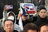 Protesters against President Yoon Suk Yeol's impeachment hold up their pickets on March 7 in front of the presidential residence at Yongsan District, central Seoul, as they hear the news of Yoon's arrest being overturned by the court. [YONHAP]