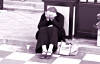 Stock photo of a woman burying her face in her palms on the curb [GETTY IMAGES]