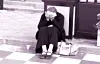 Stock photo of a woman burying her face in her palms on the curb [GETTY IMAGES]