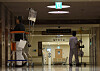 Patients walk down a darkened corridor in an unspecified major hospital in Seoul on Sunday. [YONHAP]