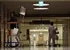 Patients walk down a darkened corridor in an unspecified major hospital in Seoul on Sunday. [YONHAP]