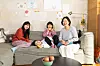 Creators and models of the children's book ″If You Want to Eat a Red Apple″ (2024) pose for photos at photographer Lee Ga-hee's home in Incheon, last month. From left are Lee, her children Ji-gu and Ji-ho and writer Jin Joo. [JOONGANG ILBO]