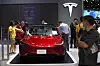 Visitors inspect a Tesla Model 3 electric car displayed at the 40th Thailand International Motor Expo 2023 in Bangkok, Thailand, on Dec. 4. [EPA/YONHAP]